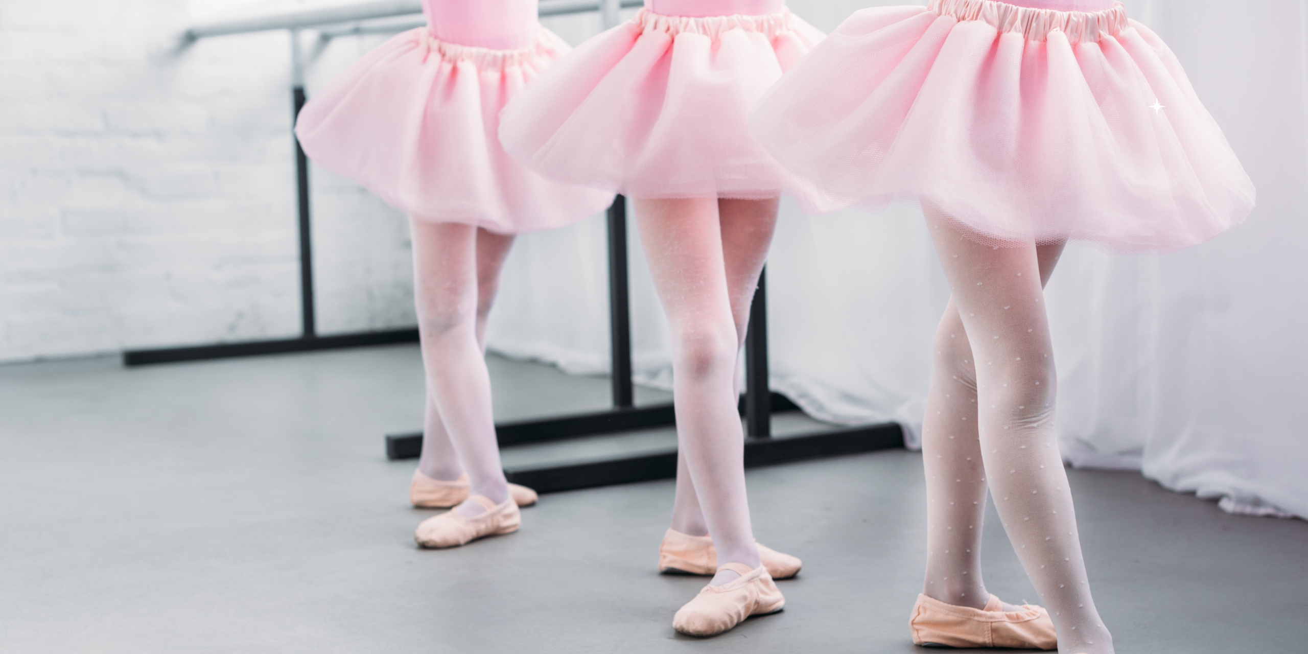 Three ballerina at the bar Three ballerina at the bar wearing pick tutus, tights and spft ballet shoes.